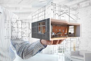 Hombre sujetando maqueta de edificio virtual