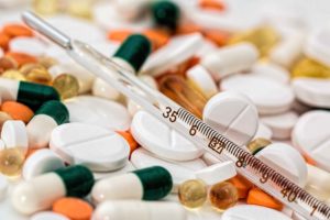 Pastillas de diversos tipos junto a jeringuilla