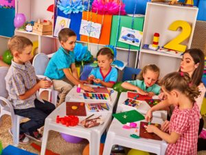 Ludoteca en la que juegan varios niños con una supervisora