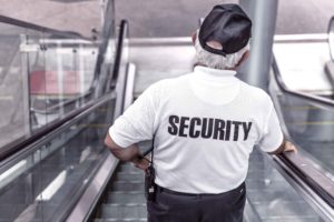 Guardia de seguridad bajando por escaleras mecánicas